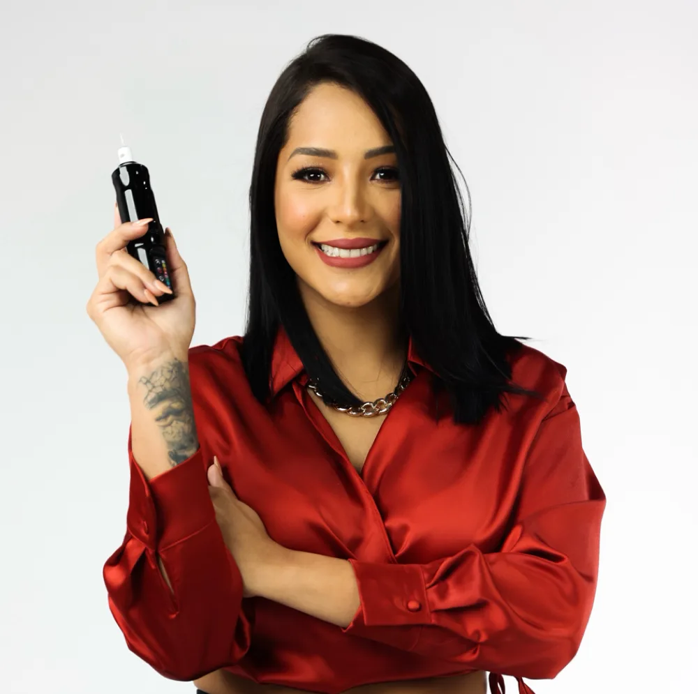 Andreina Angulo, owner and esthetician of AJ Beauty Studio, holding her permanent makeup device